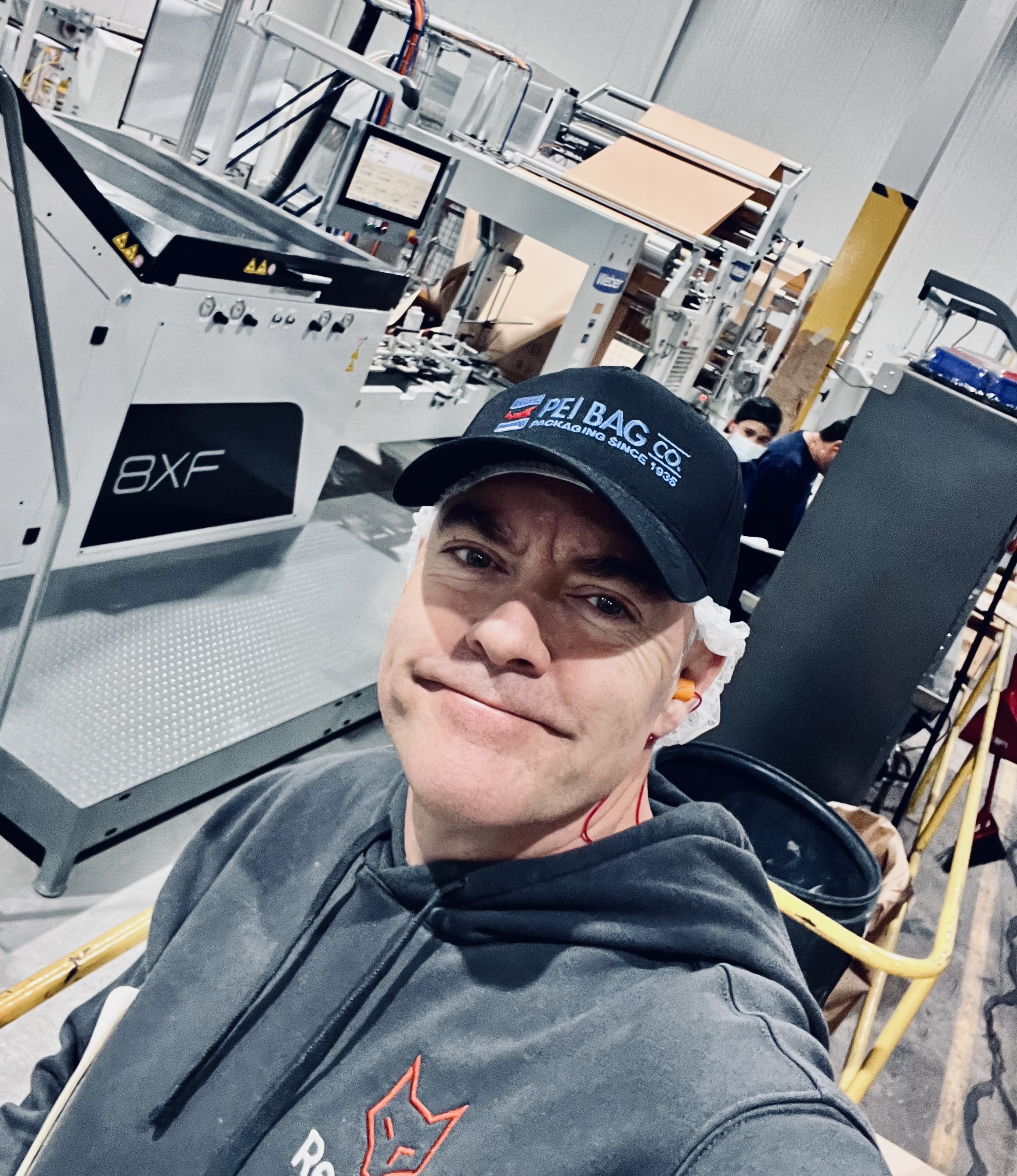Brian Stewart on a packaging production floor, wearing RedFox workwear